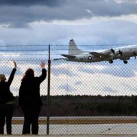 Women nod after plane in Naval Air Station Brunswick