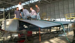Specialists doing some repair for wing at Robins AFB