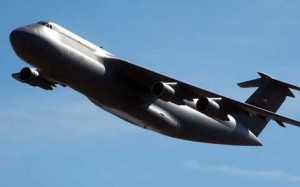 Logistics plane at flies over Aitos Logistics Center