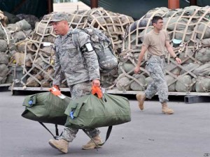 Soldier carrying bags at Transit Center at Manas